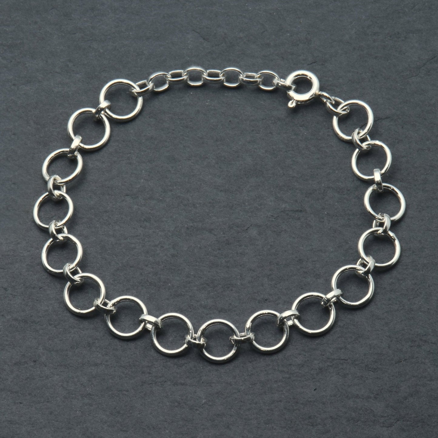 Silver bracelet with circle links on a slate background