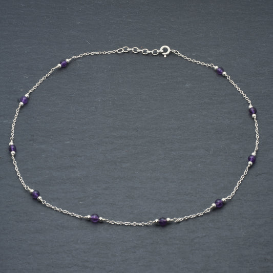 Amethyst bead chain necklace on slate background