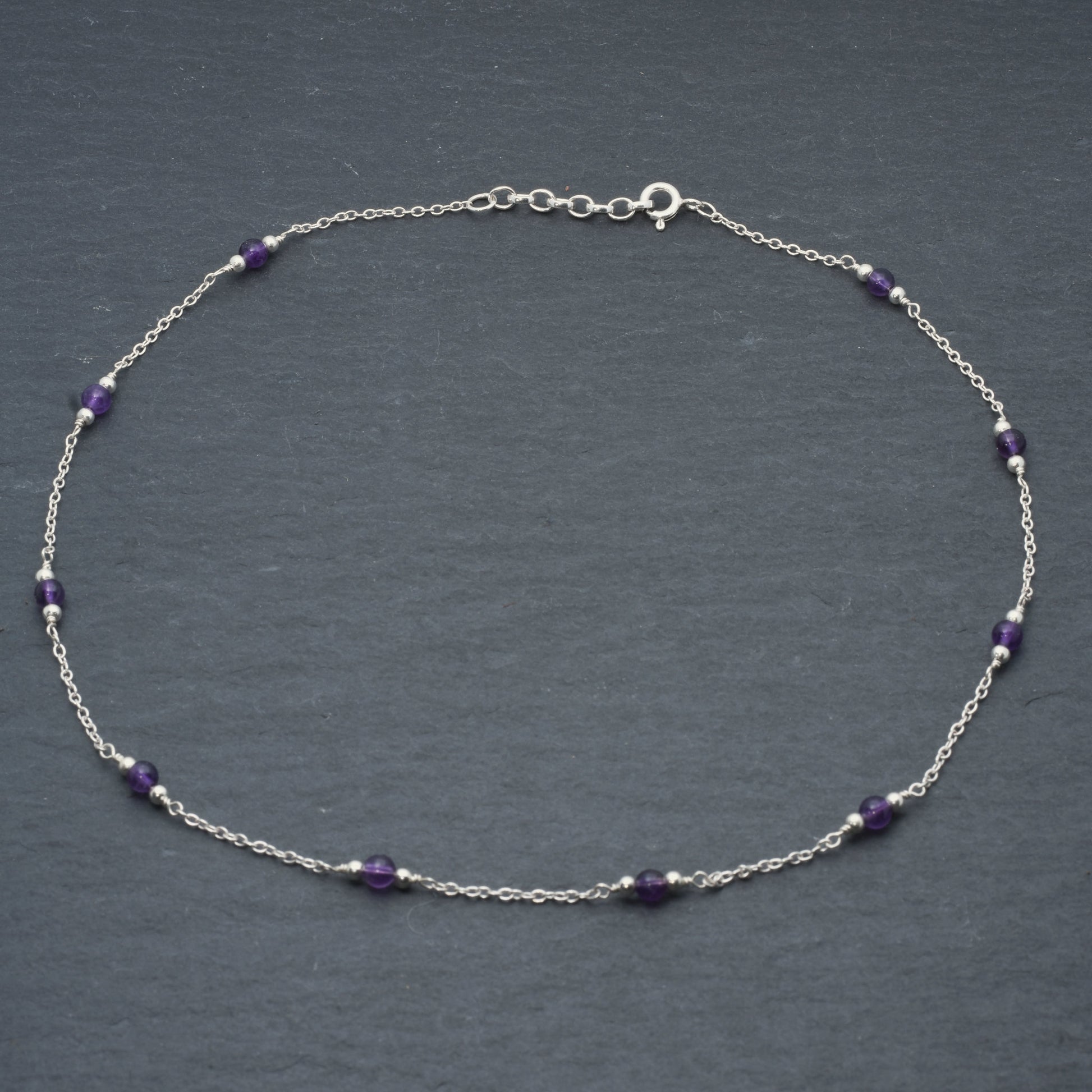 Amethyst bead chain necklace on slate background