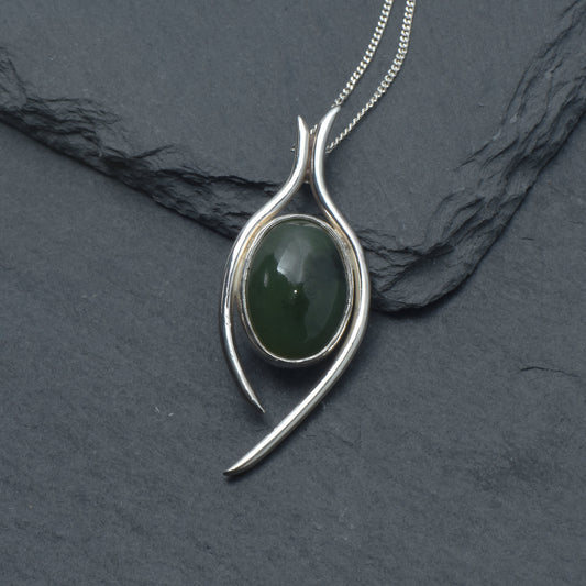Jade and Silver pendant on a slate background